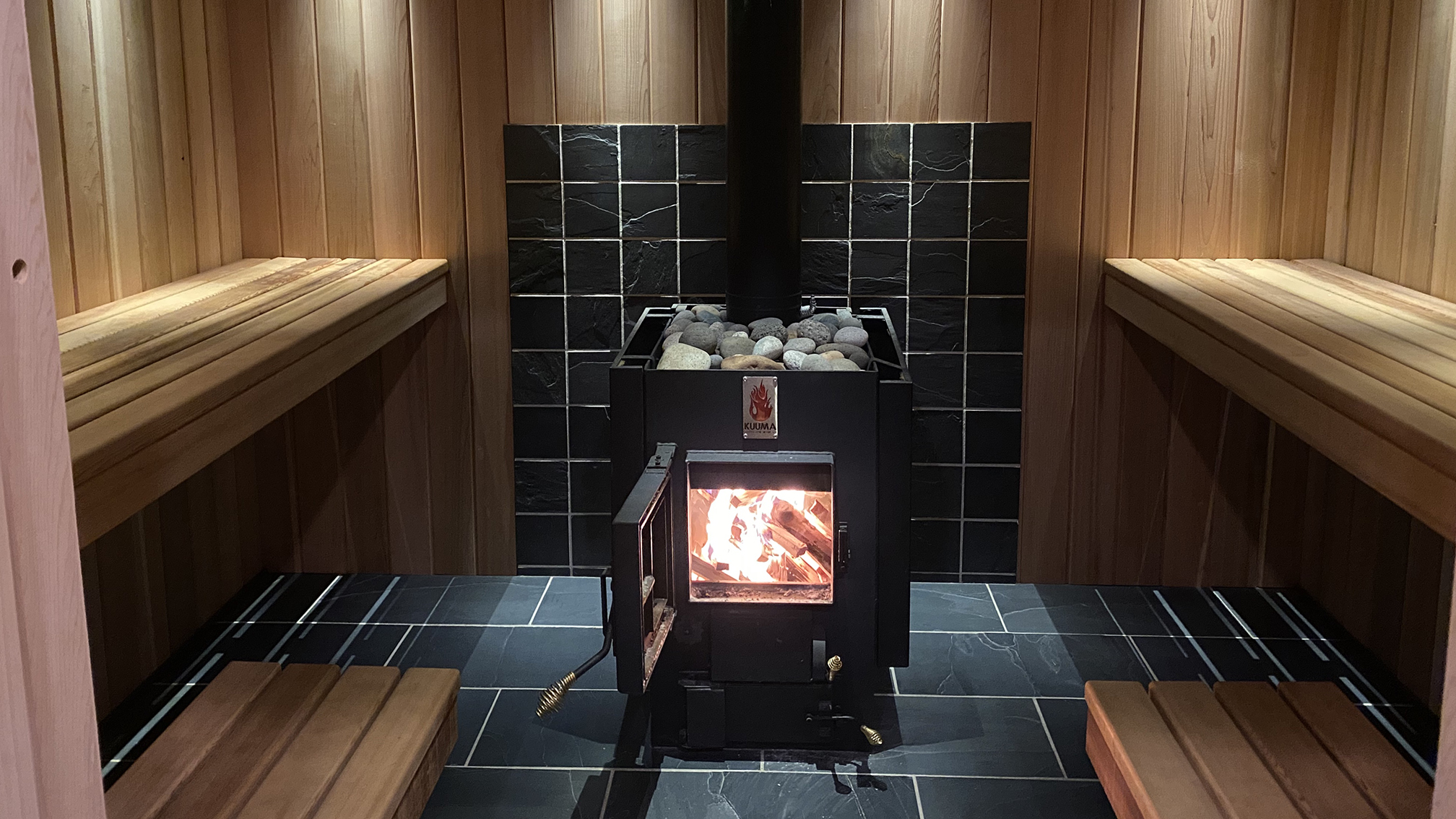 the imogene's wood burning sauna, image of the benches and wood burning stove